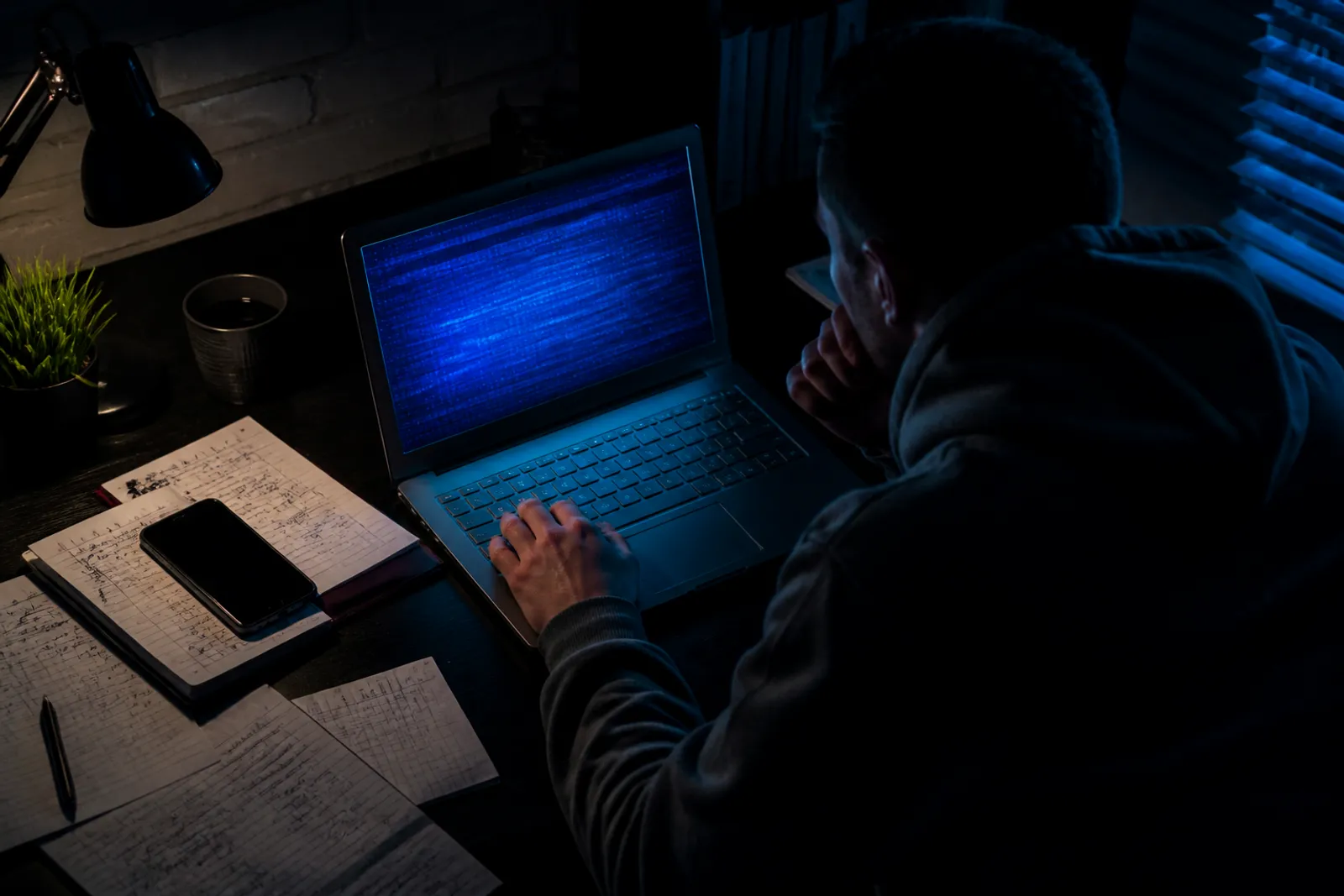 A person deeply engaged in browsing a list of .onion links on a laptop.